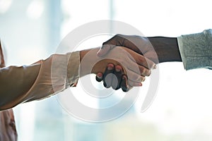 Well become the best of business partners. Closeup shot of two unidentifiable businesspeople shaking hands in an office.