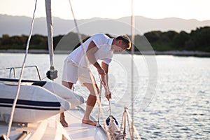 Well-built man in white tshirt on the yacht