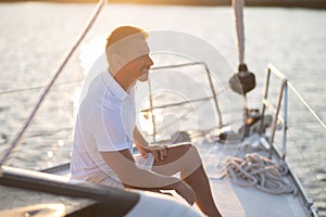 Well-built man in white tshirt on the yacht