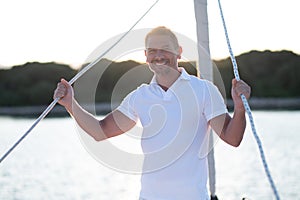 Well-built man in white tshirt on the yacht