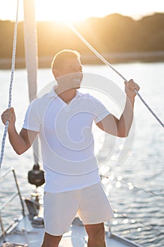 Well-built man in white tshirt on the yacht