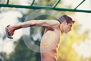 Well built muscular man doing a physical exercise