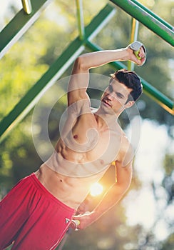 Well built muscular man doing a physical exercise