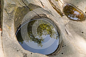 A well carved into the rock by a mountain river, rocks in the carpathians, background, nature