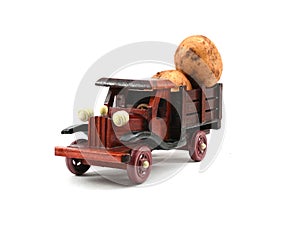 Well crafted colorful wooden toy pick up truck carrying potatoes isolated on white background