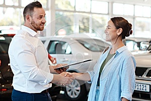 Well definitely find you the car you want. Shot of a businessman shaking hands with his customer.