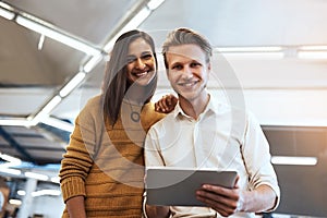 Well definitely get it done. Cropped portrait of two young businesspeople looking at a tablet in their office.