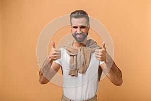 Well done, excellent job. Portrait of smiling satisfied man standing with thumbs up, like gesture, demonstrating