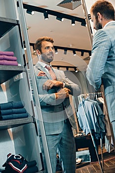 Well-dressed businessman adjusting cufflinks