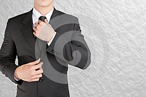 Well dressed businessman looklike smart adjusting his neck tie