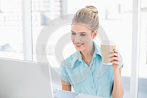 Well dressed businesswoman holding coffee