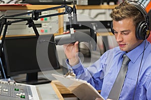 Well dressed focused radio host moderating