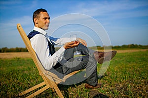 Well Dressed Man Tasting Glass Of Wine At Winefarm photo