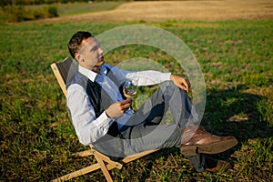 Well Dressed Man Tasting Glass Of Wine At Winefarm photo