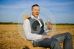 Well Dressed Man Tasting Glass Of Wine At Winefarm photo