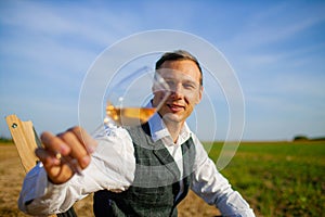 Well Dressed Man Tasting Glass Of Wine At Winefarm photo