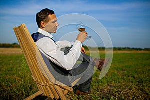 Well Dressed Man Tasting Glass Of Wine At Winefarm photo