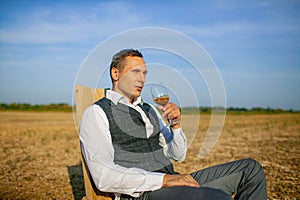 Well Dressed Man Tasting Glass Of Wine At Winefarm photo
