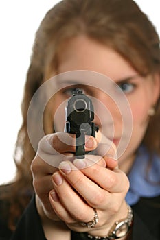 Well-dressed woman standing and aiming a handgun