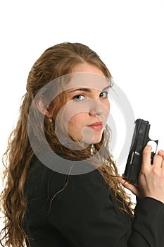 Well-dressed woman standing and holding a handgun