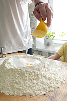 Well in flour, eggs and water. put in the dough hole. Preparation of dough for dumplings