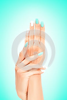 Well-groomed female hands with mint-white manicure
