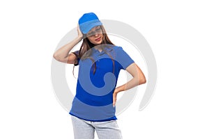 well-groomed young brunette woman promoter in a blue t-shirt and cap on a white background with copy space