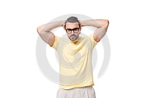 well-groomed young caucasian man with black hair and beard wears glasses for image