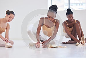 Well have our break on the floor. Shot of a group of young ballerinas preparing for rehearsal.