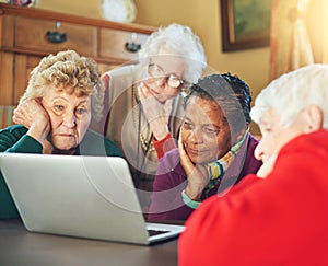 Well how about that. a group of senior women using a laptop at a senior centre.