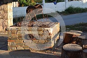 The well with interesting details and stumps next to it