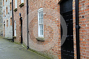 Well-kept brick and stone buildings on cobblestone walkway