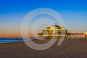 The well known pier jetty of Blankenberge beach, Beglium, Beautiful coast with blue water and a colorful sky during sunset