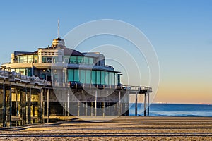 The well known pier jetty of Blankenberge, belgium, touristic holiday spot, belgian beach with beautiful and colorful sky