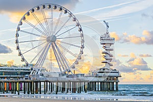 Well-known pier jetty of scheveningen beach the Netherlands with bungy jump tower and ferris wheel viewing on the ocean with