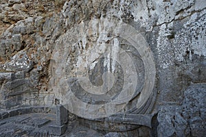 The well-known relief of a Rhodian trireme, warship, cut into the rock at the foot of the steps leading to the acropolis. Rhodes