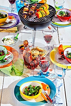 Well Laid summer table with colorful dish and brazier photo