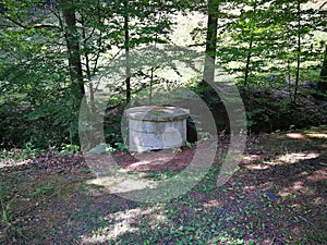 A well made of concrete rings built in the forest