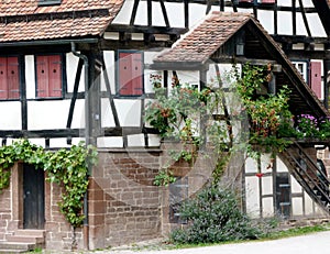 Well maintained half-timbered house with a covered staircase and closed shutters