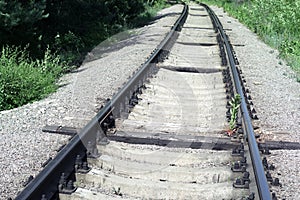 Well-maintained railway track for non-passenger special purposes. Steel rails on concrete sleepers. elongated wooden sleepers are