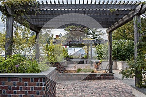 A well manicured sensory garden framed by a wooden pergola