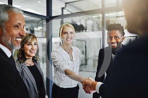 Well no doubt work very well together. businesspeople shaking hands in an office.