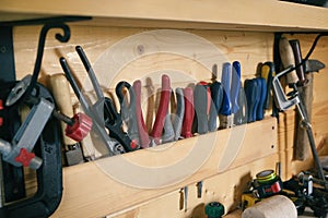 Well organizied construction carpentry tools on board in woodworker workshop. DIY concept