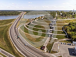 A well-planned city road interchange near the recreational touristic zone at the river background. A view from a height to the wel