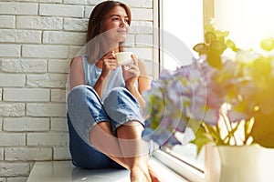 A well-pleased young girl enjoying an ideal day sitting in the w