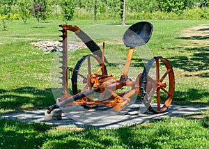 A well-preserved, colorful old-time grass mower operating on horsepower, Saaremaa Island, Estonia