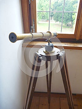 Well preserved old hostoric binocular at the window photo