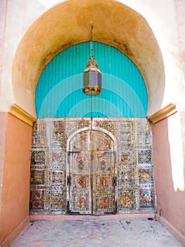 Well preserved old Moroccan door with a colorful traditional lan
