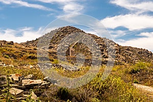 Well preserved Temple of Isis on Delos Island located on the hill above the ancient city with other ruins, Greece.