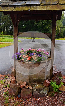 Old well used as a planter for flowers
